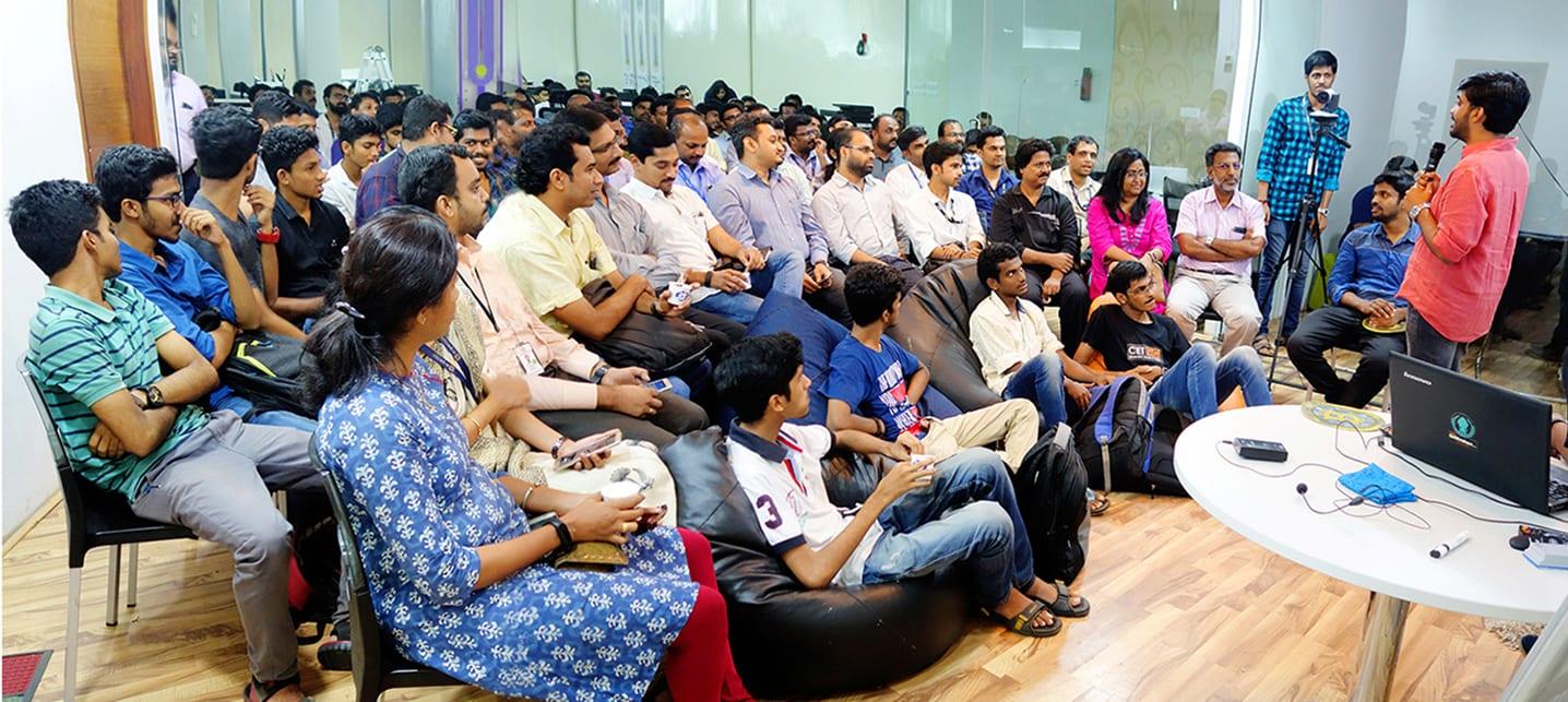 A full room of developers, founders and students listening to a speaker at a FAYA:80 session in Technopark.